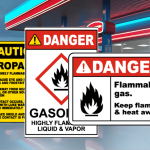 Safety signs at a fuel station reminding staff and customers of rainy day safety precautions